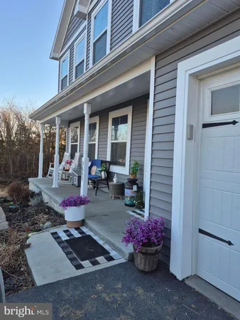 a view of a chairs and table in backyard