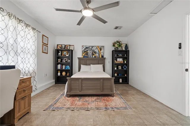 a living room with a couch and a bookshelf