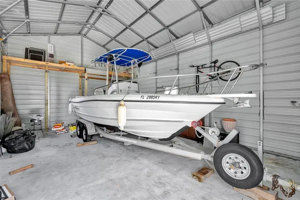 a room with water heater and racks on the wall