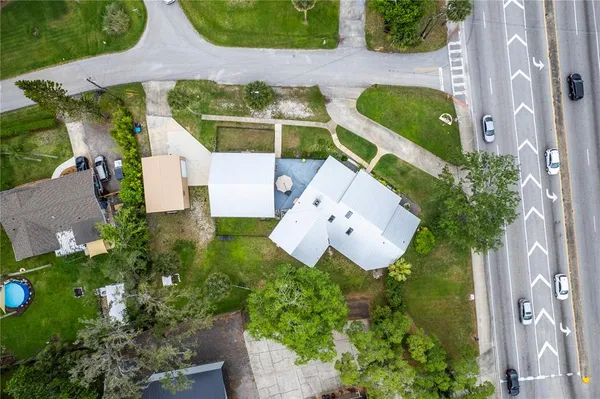 an aerial view of a house with outdoor space and tennis court