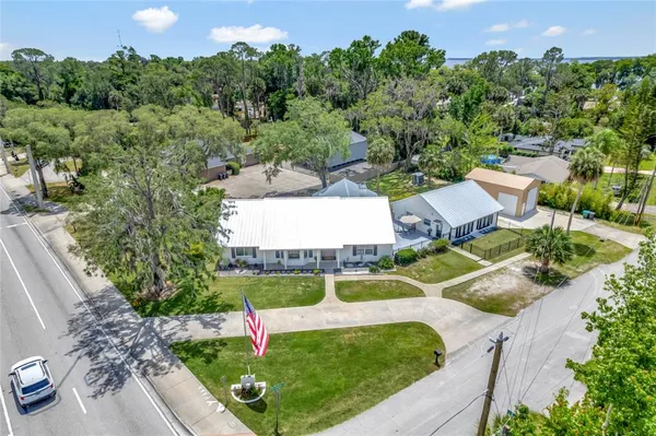 an aerial view of a house with garden space and street view