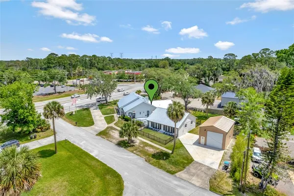 an aerial view of a house with swimming pool and garden view