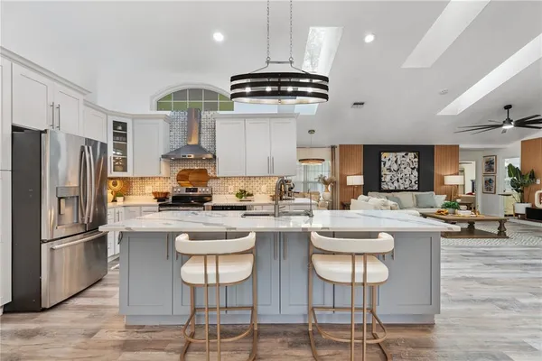 a kitchen with a sink stainless steel appliances and cabinets