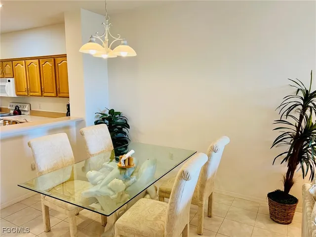 a dining room with furniture and a potted plant