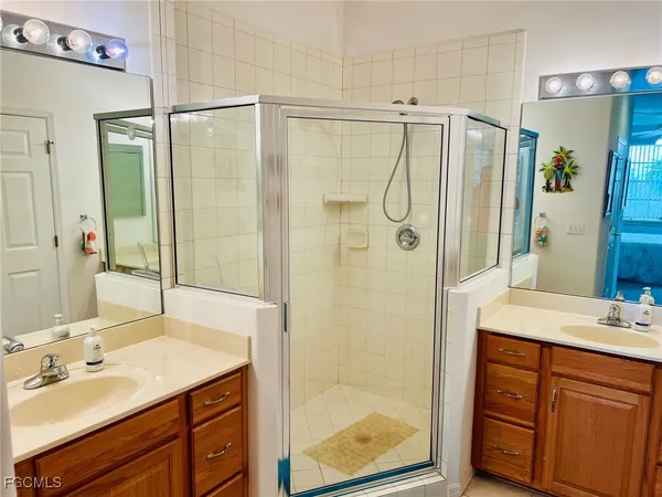 a bathroom with a shower sink and mirror