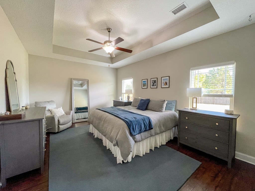 6 Cheyenne Trail Fort Mitchell, AL 36856 - Photo 14 of 33 a spacious bedroom with a bed and a chandelier