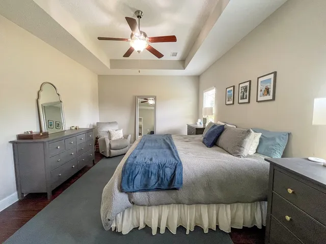 a bedroom with a bed and a dresser