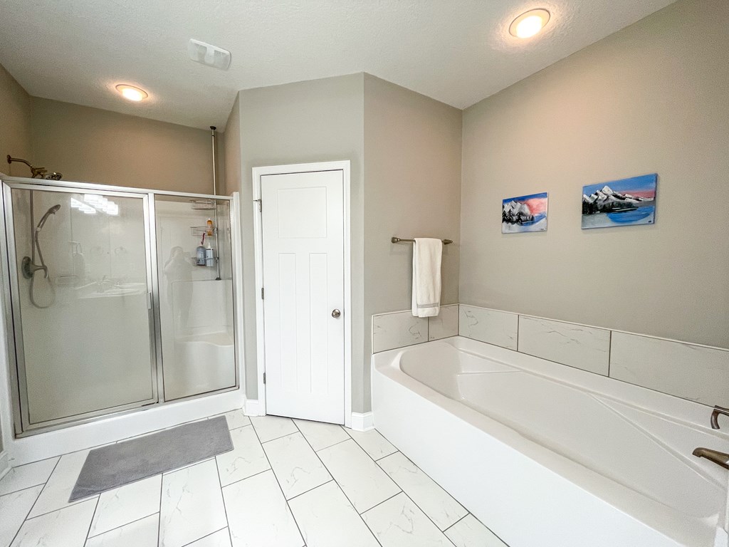 6 Cheyenne Trail Fort Mitchell, AL 36856 - Photo 17 of 33 a bathroom with a bathtub and a shower