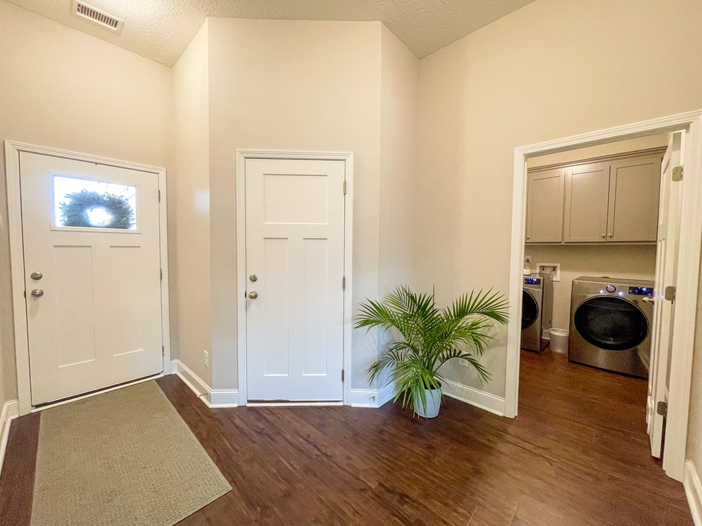 6 Cheyenne Trail Fort Mitchell, AL 36856 - Photo 2 of 33 a view of a hallway with wooden floor and a couch