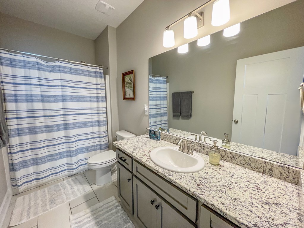 6 Cheyenne Trail Fort Mitchell, AL 36856 - Photo 22 of 33 a bathroom with a granite countertop sink and a mirror