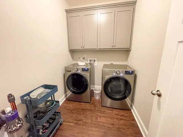 a view of a storage and utility room with a washer dryer