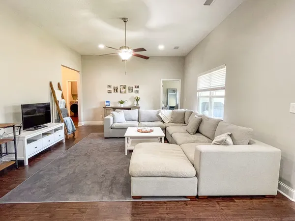 a living room with furniture and a flat screen tv