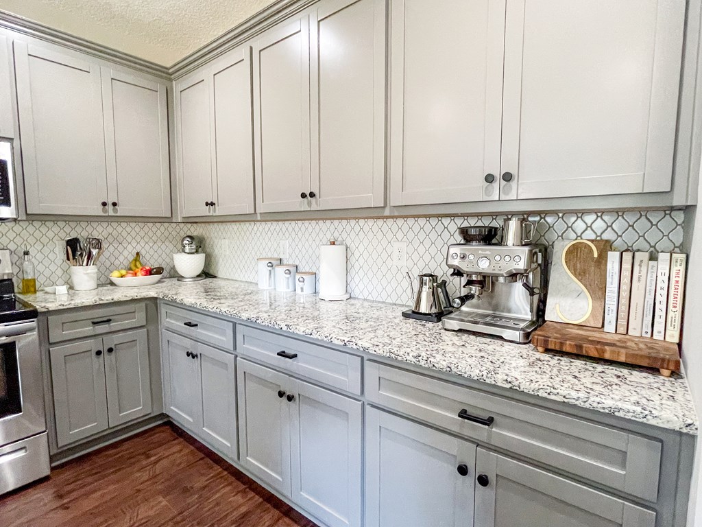 6 Cheyenne Trail Fort Mitchell, AL 36856 - Photo 10 of 33 a kitchen with granite countertop white cabinets and white appliances