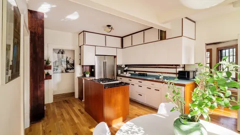 a bedroom with a bed and a table with chair