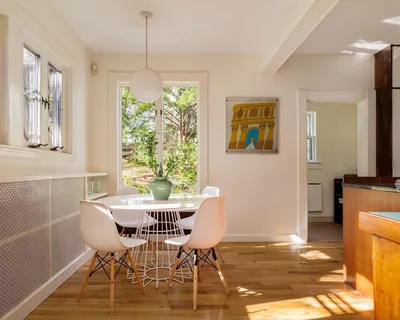 a view of a hallway with wooden floor windows and a chandelier