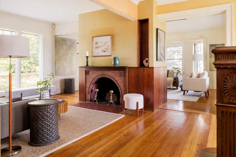 a living room with furniture a flat screen tv and a fireplace