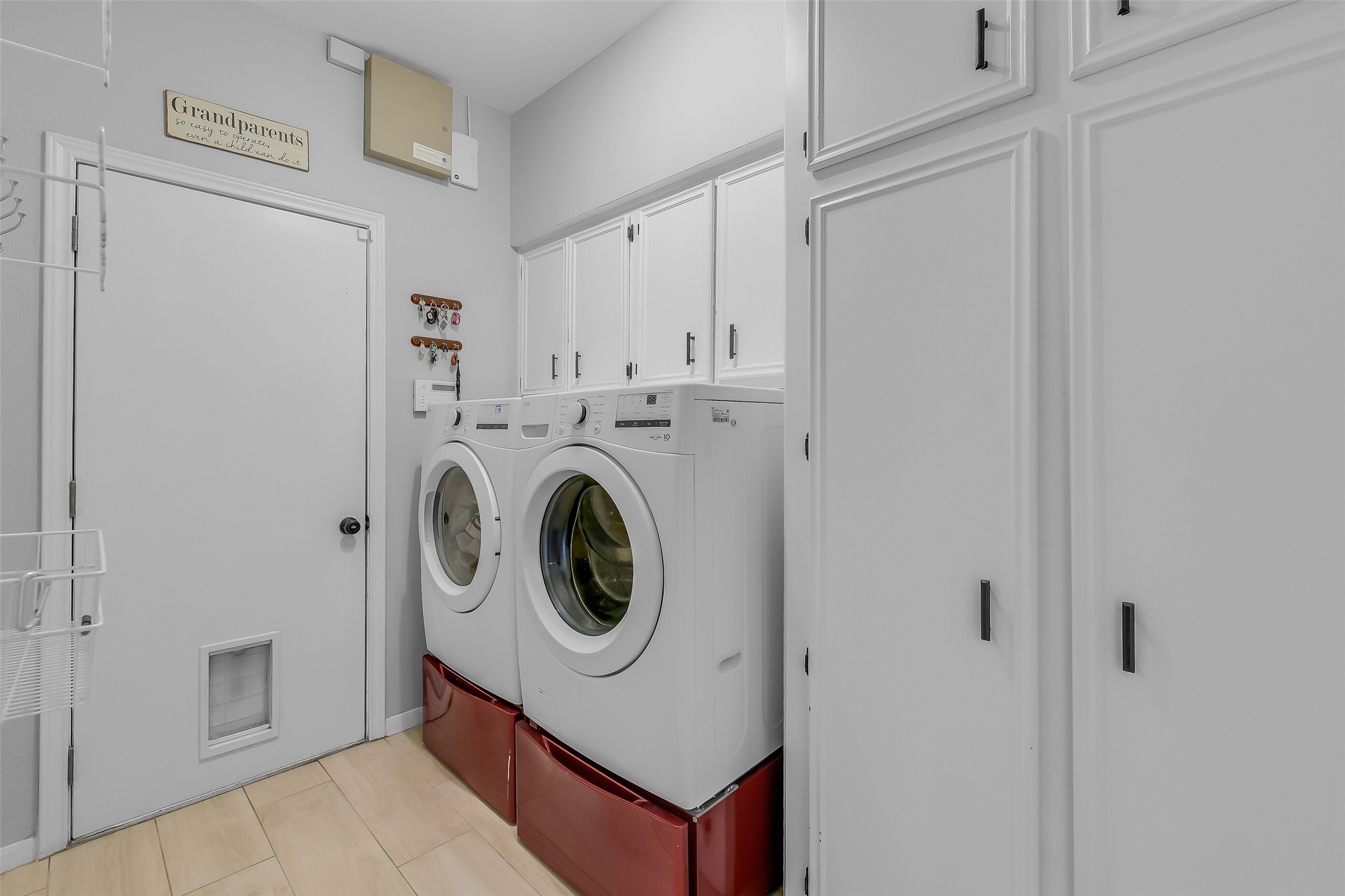 26 Split Rock Road Spring, TX 77381 - Photo 22 of 40 This laundry room is well-organized, featuring ample storage and a light wood floor.