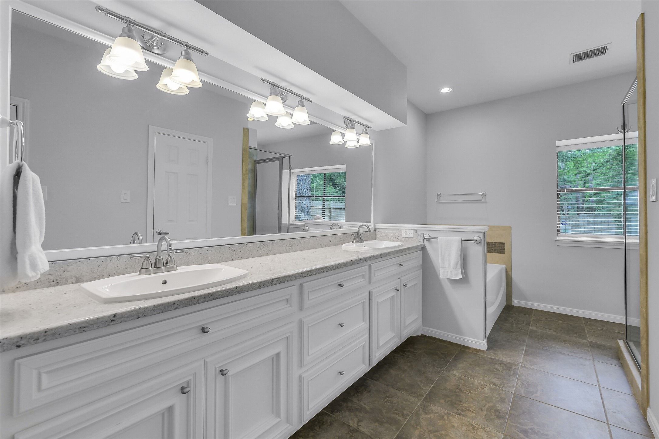 26 Split Rock Road Spring, TX 77381 - Photo 27 of 40 Primary bathroom with dual sinks, soaking tub, separate shower, and two walk in closets.