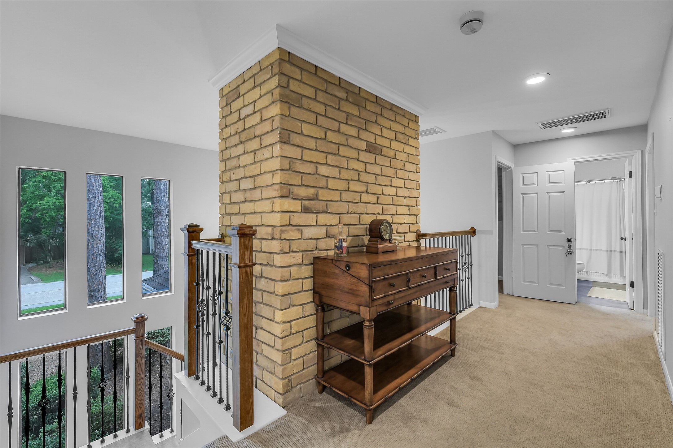 26 Split Rock Road Spring, TX 77381 - Photo 30 of 40 This photo showcases a bright upstairs landing area featuring a striking brick pillar.