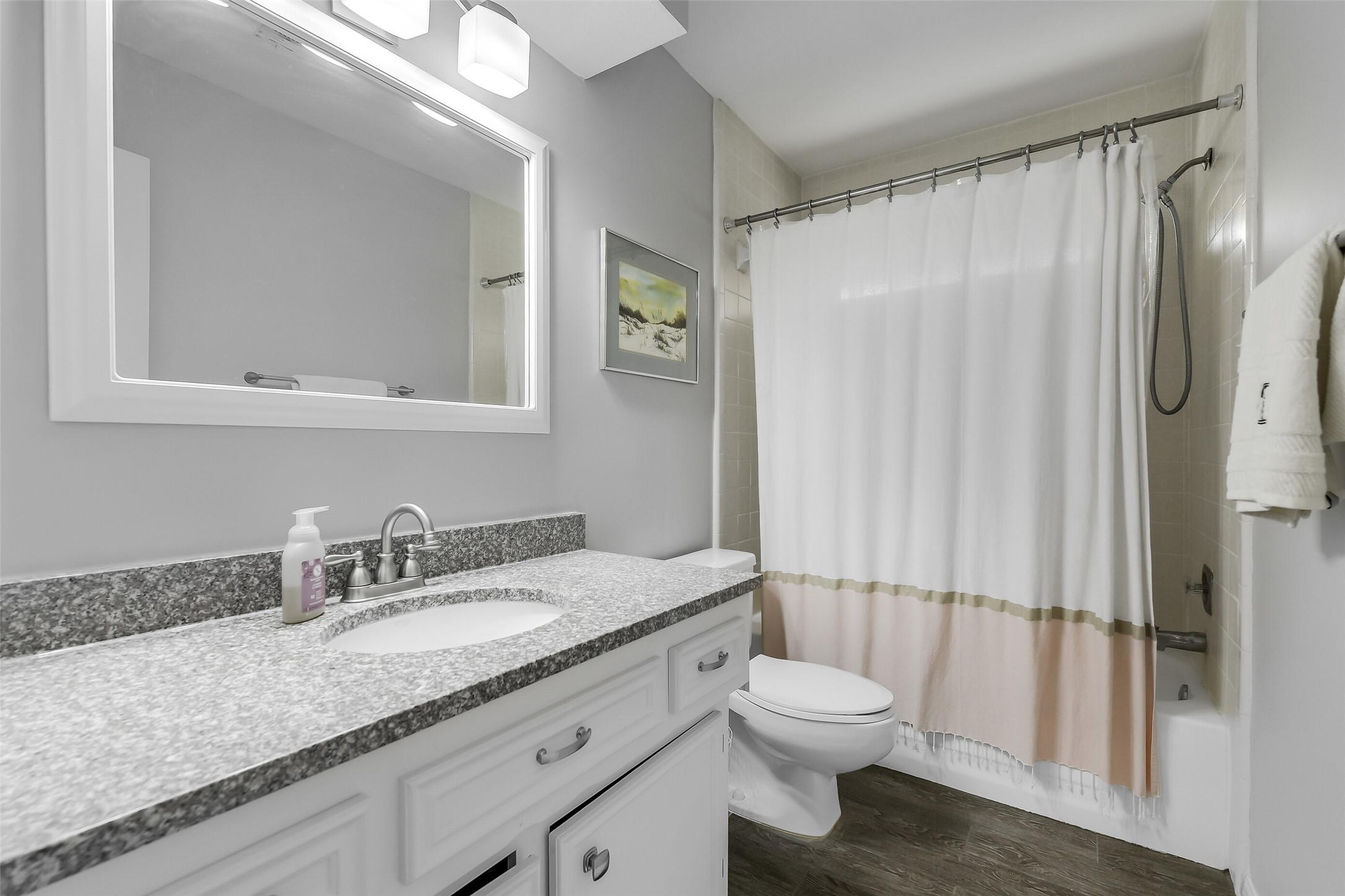 26 Split Rock Road Spring, TX 77381 - Photo 34 of 40 This upstairs third bathroom features a sleek design with a granite countertop, white cabinetry, and a modern sink. It includes a shower-tub combo, stylish lighting, and a neutral color palette for a clean, fresh look.