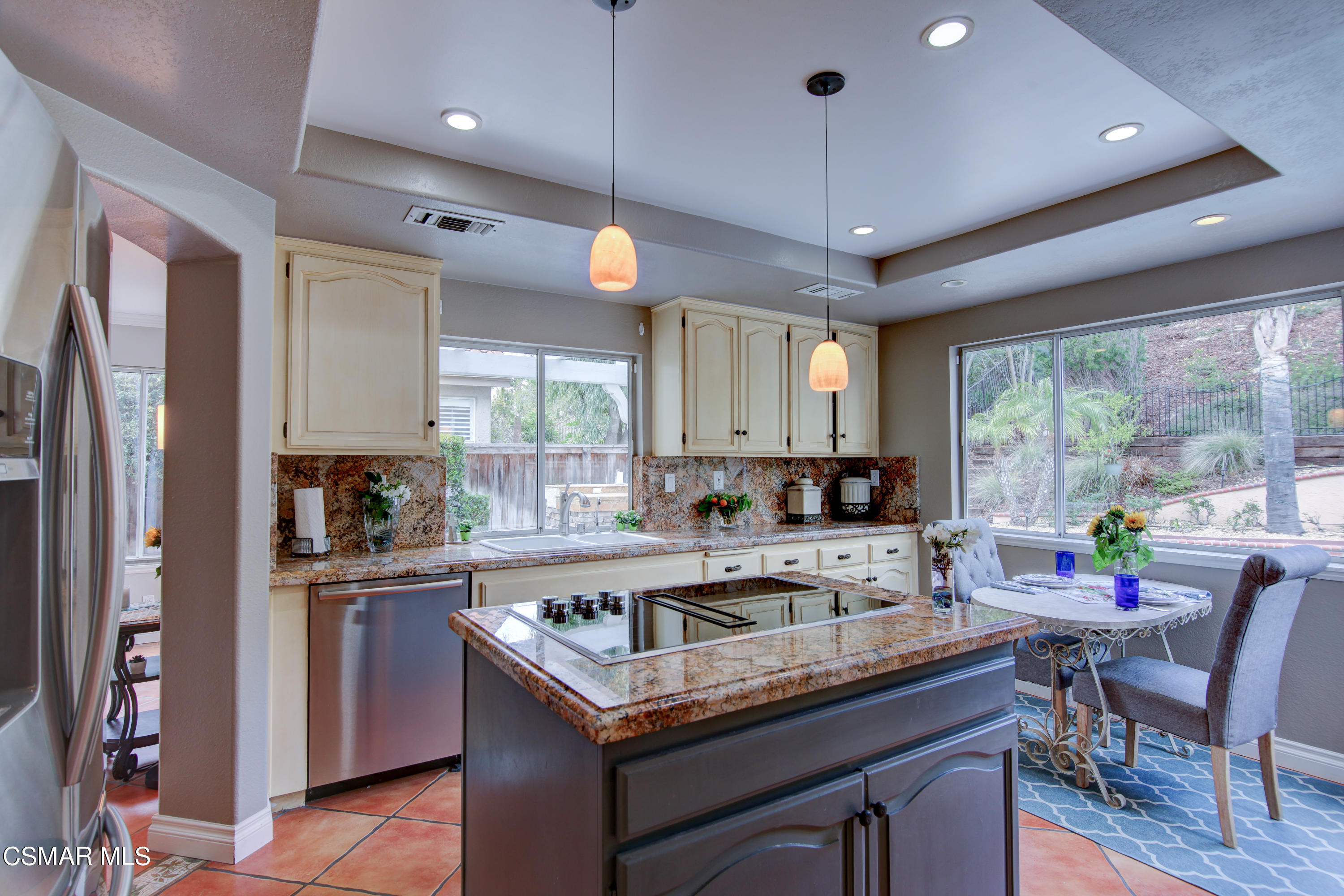 445 Innwood Road Simi Valley, CA 93065 - Photo 6 of 44 a kitchen with a stove a sink a center island and cabinets