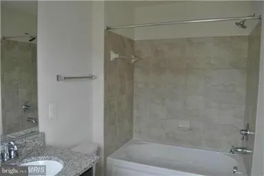 a bath room with a bath tub and a shower