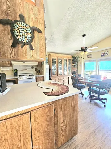 a kitchen with stainless steel appliances kitchen island granite countertop a sink and cabinets