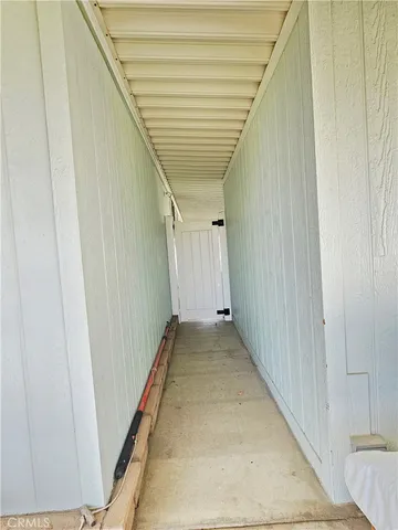 a building outdoor space with patio furniture and potted plants