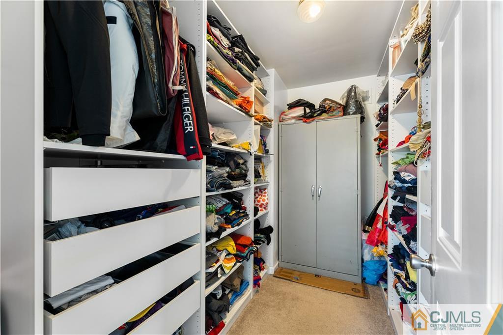 18 Baxter Road Edison, NJ 08817 - Photo 24 of 32 a view of walk in closet with clothes and shoes