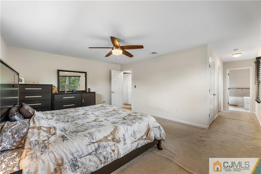 18 Baxter Road Edison, NJ 08817 - Photo 27 of 32 a bed room with a bed and a ceiling fan