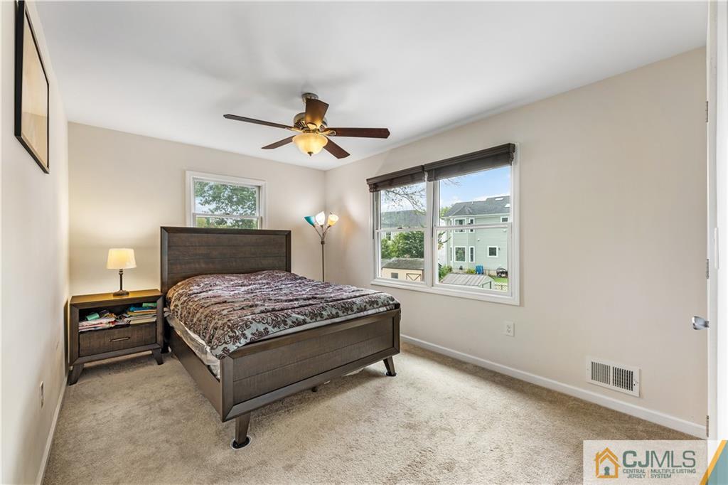 18 Baxter Road Edison, NJ 08817 - Photo 29 of 32 a bedroom with a bed and a chandelier