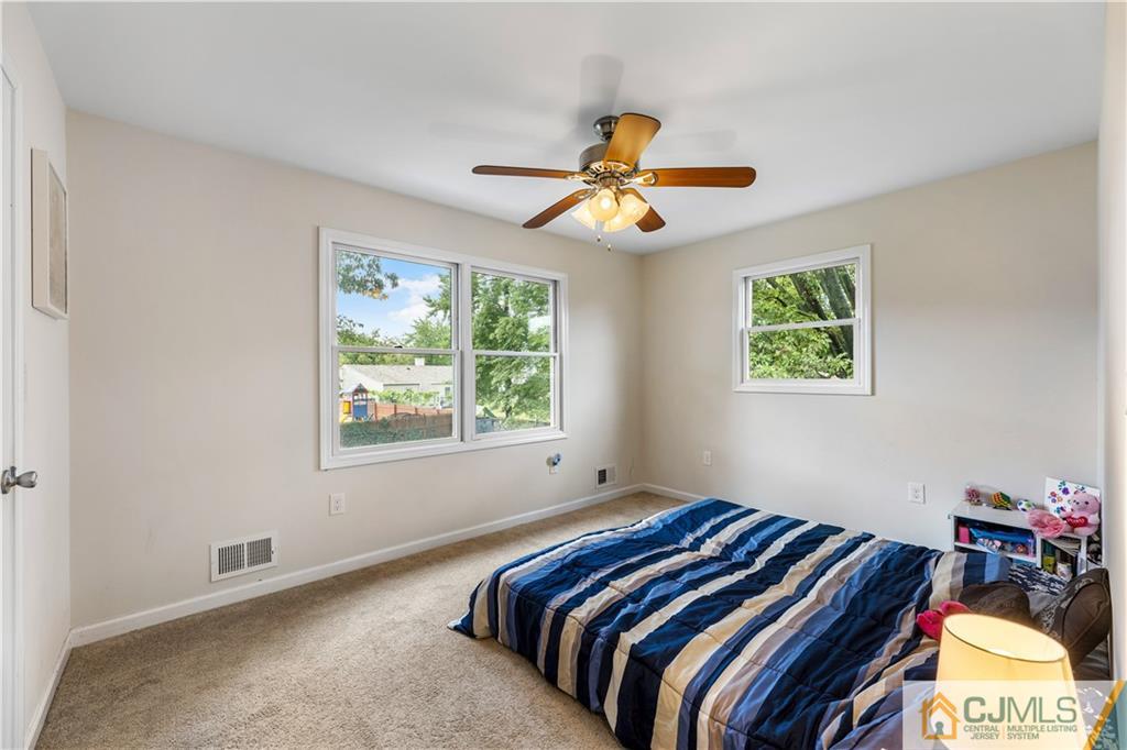 18 Baxter Road Edison, NJ 08817 - Photo 30 of 32 a bedroom with a bed and a chandelier