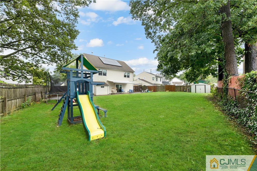 18 Baxter Road Edison, NJ 08817 - Photo 4 of 32 a view of a house with a backyard and a slide