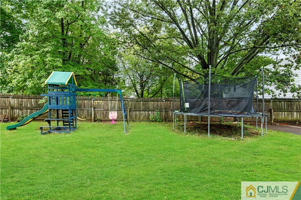 18 Baxter Road Edison, NJ 08817 - Photo 5 of 32 a view of a park with wooden fence and a bench