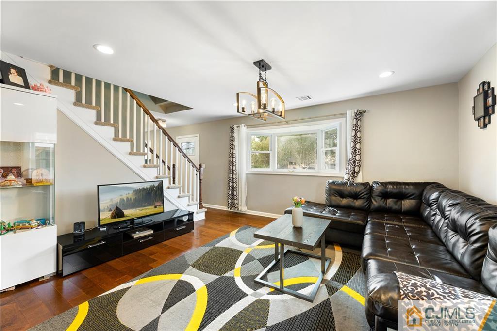 18 Baxter Road Edison, NJ 08817 - Photo 10 of 32 a living room with furniture and a flat screen tv