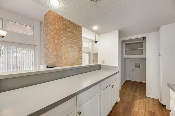 a view of a kitchen cabinets a sink and wooden floor