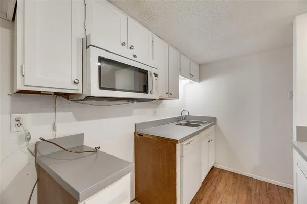 a kitchen with a sink cabinets and microwave