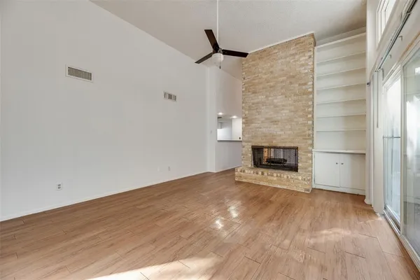a view of an empty room and fire place