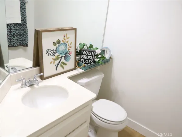 a white toilet sitting next to a bathroom sink