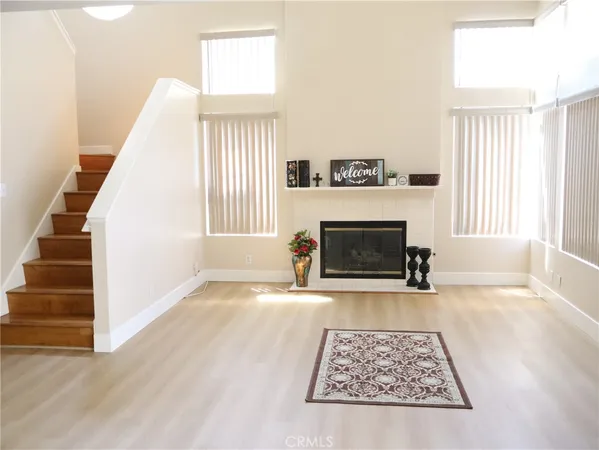 a view of a livingroom with a fireplace and window