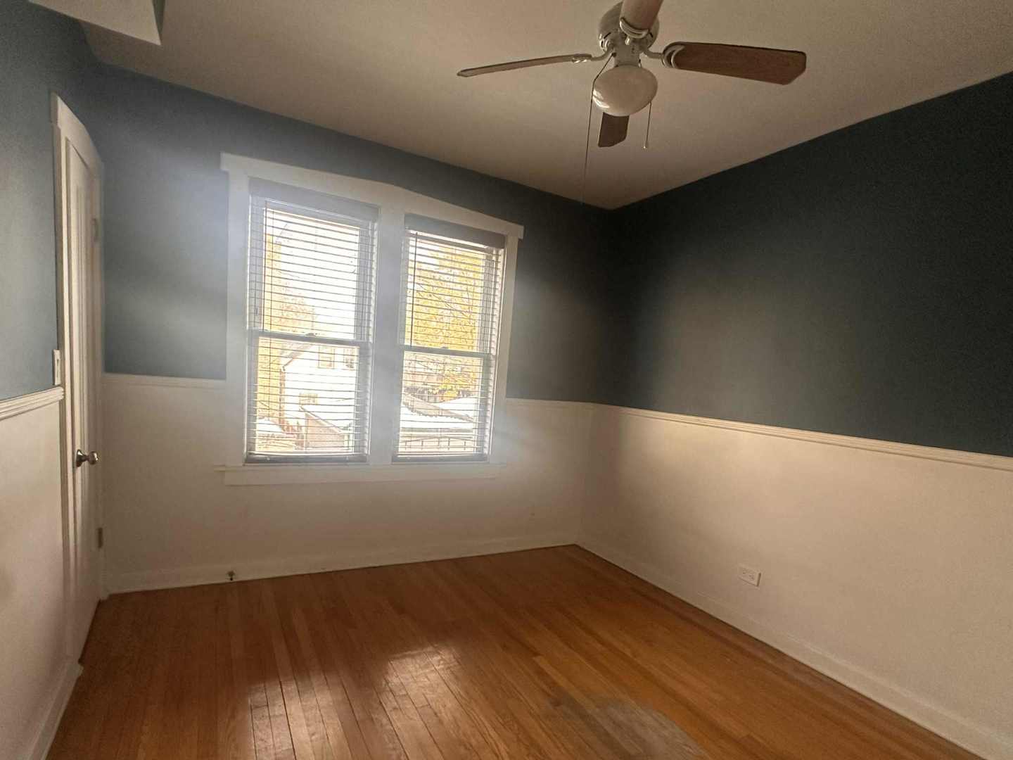 3719 West Hirsch Street, Unit 2 Chicago, IL 60651 - Photo 11 of 13 an empty room with wooden floor fan and windows