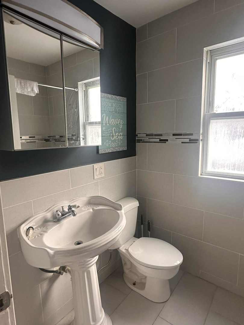 3719 West Hirsch Street, Unit 2 Chicago, IL 60651 - Photo 13 of 13 a bathroom with a sink and a toilet