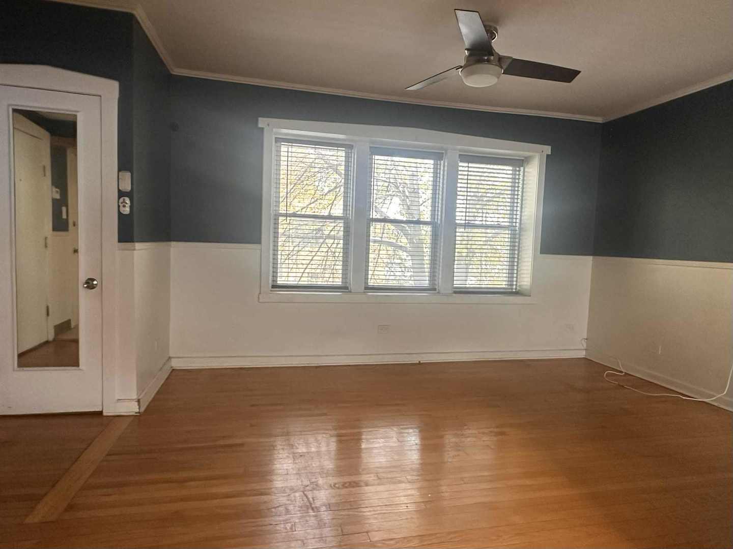 3719 West Hirsch Street, Unit 2 Chicago, IL 60651 - Photo 3 of 13 a view of an empty room with wooden floor and a window