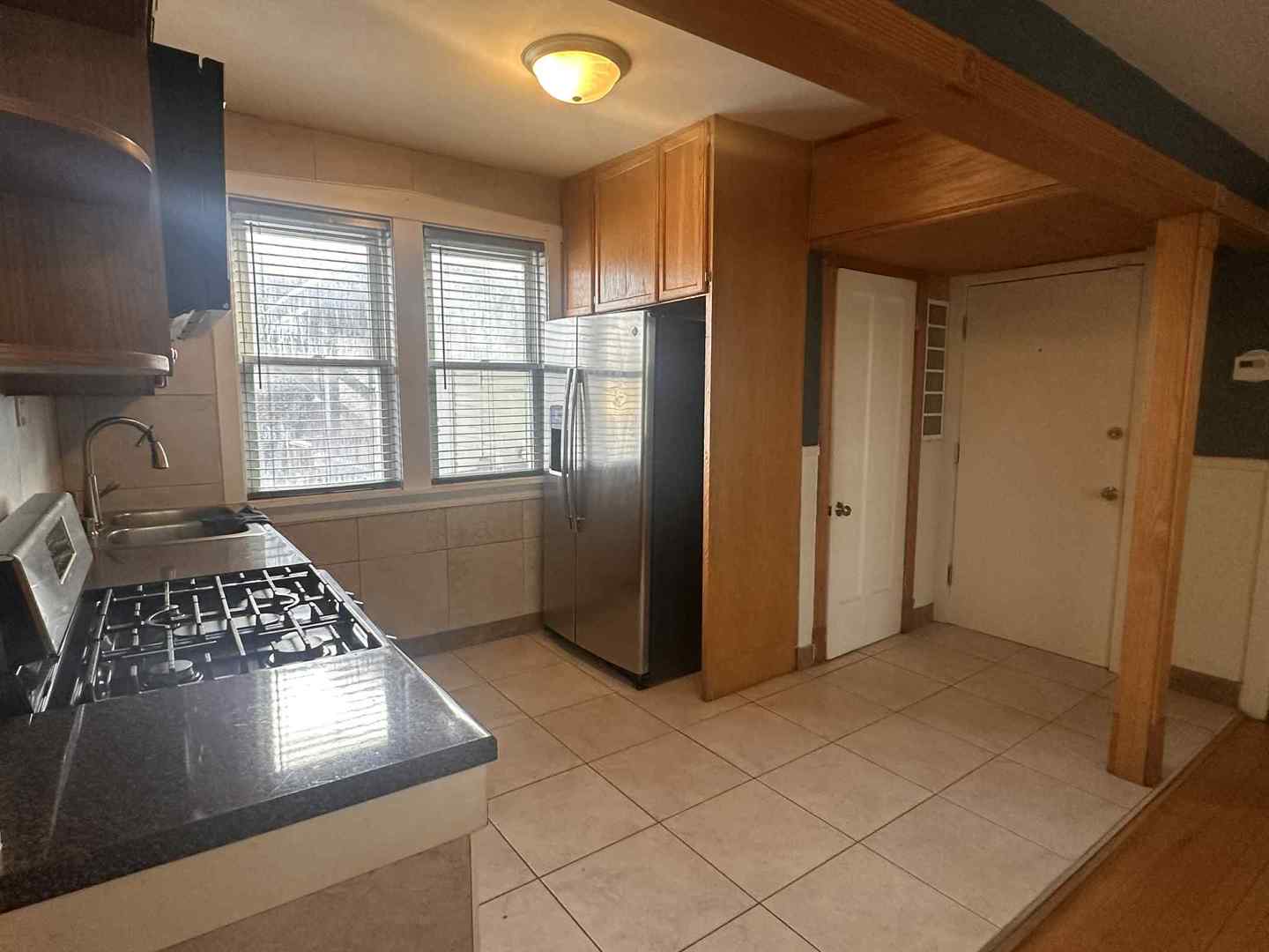 3719 West Hirsch Street, Unit 2 Chicago, IL 60651 - Photo 6 of 13 a view of kitchen with windows and refrigerator