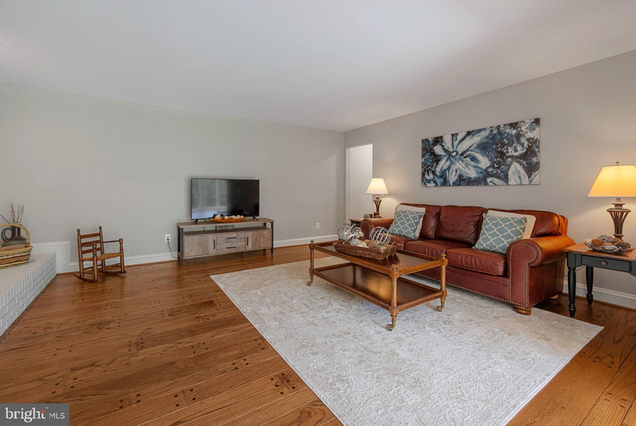 13111 Springdale Estates Road Clifton, VA 20124 - Photo 30 of 109 Warm living room with hardwood floors, brick heart