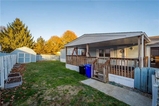 a view of a house with a yard and deck
