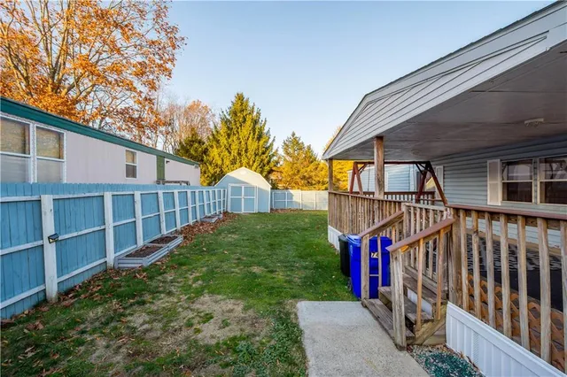 a view of a pathway of a house with wooden fence