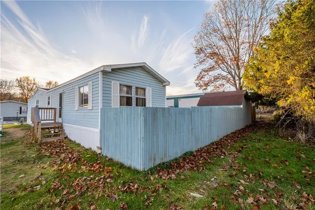 a view of a house with a wooden fence