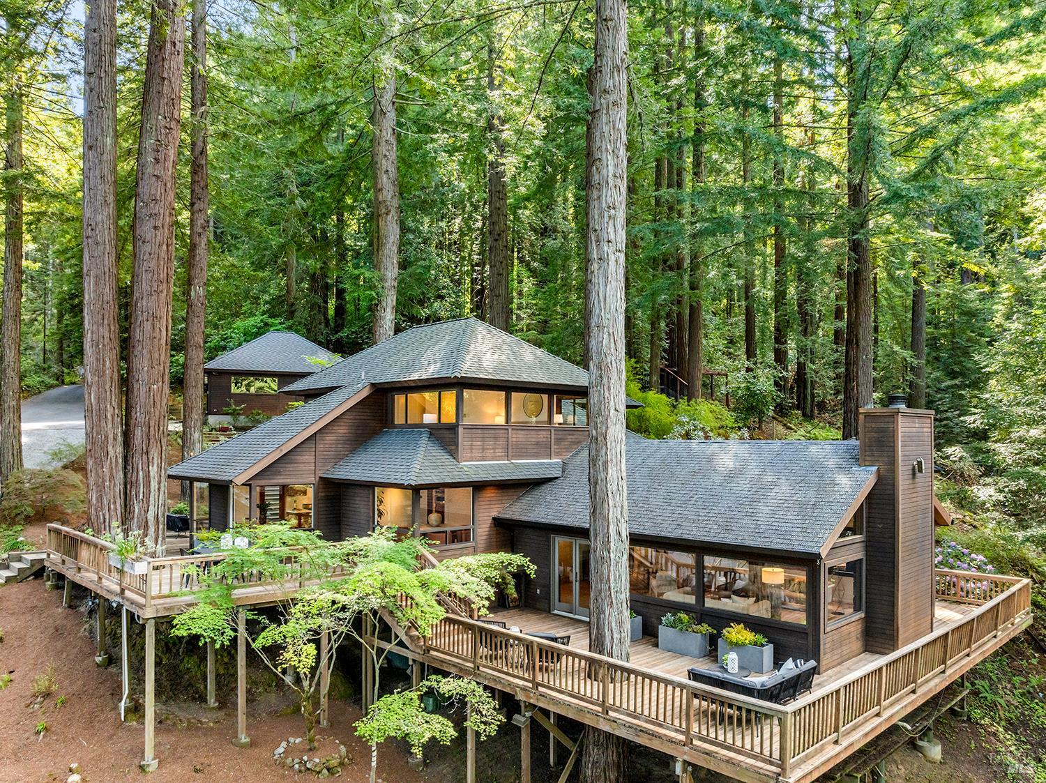 an aerial view of a house with balcony and trees