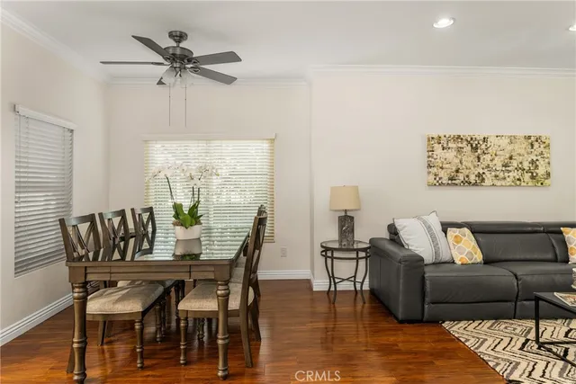 a view of a dining room with furniture and a wooden floor
